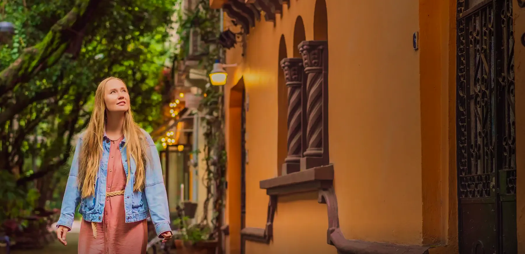 Woman walking through a sunlit street in Roma Norte, Mexico City